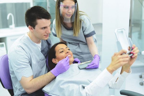 woman looking at her new smile at the dental office