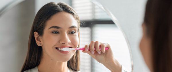 woman brushing her teeth