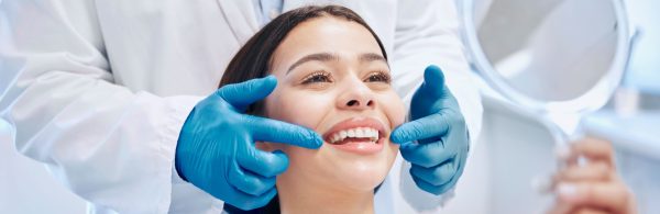 woman looking at her new smile at the dentist's office