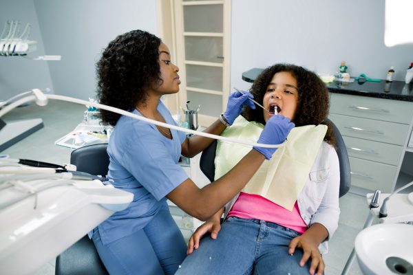 kid in a dentist office getting a dental cleaning
